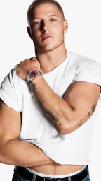 Christian McCaffrey wearing a white t-shirt and a luxury wristwatch against a solid white background for the Movado campaign.