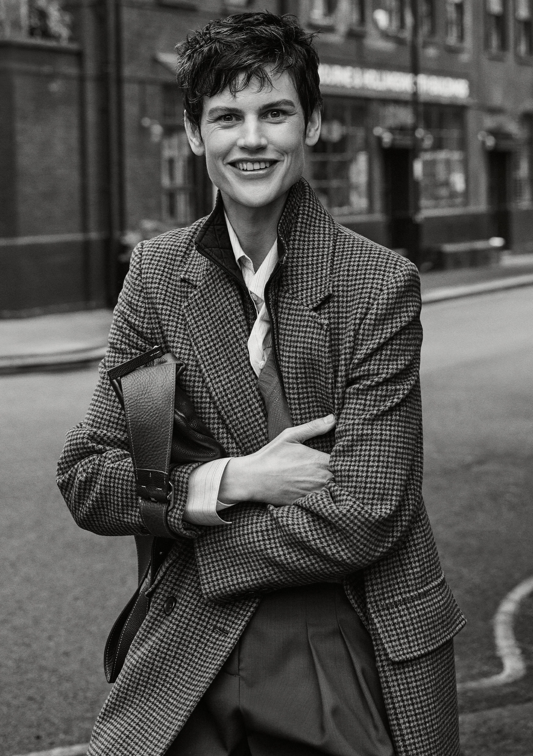Model Saskia de Brauw in houndstooth coat holding a bag on a London street for ME+EM Fall 2024 ad campaign
