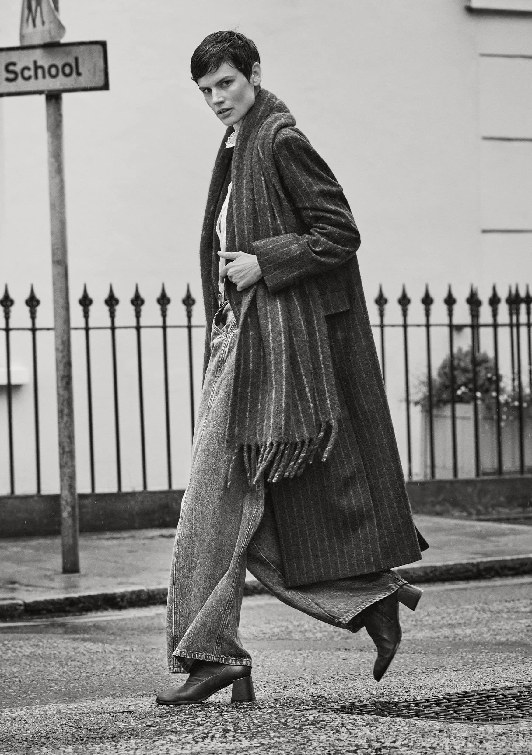 Saskia de Brauw walking on a London street in a long pinstripe coat and scarf for ME+EM Fall 2024 campaign, photographed by Cass Bird.