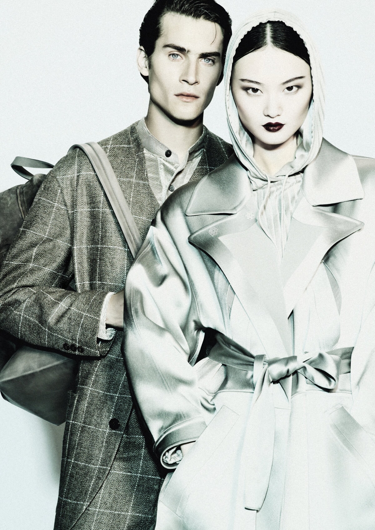 Two models wearing tailored outerwear against a white background for Giorgio Armani Fall 2024 campaign