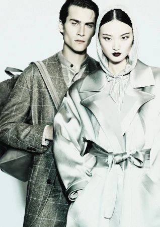 Two models wearing tailored outerwear against a white background for Giorgio Armani Fall 2024 campaign