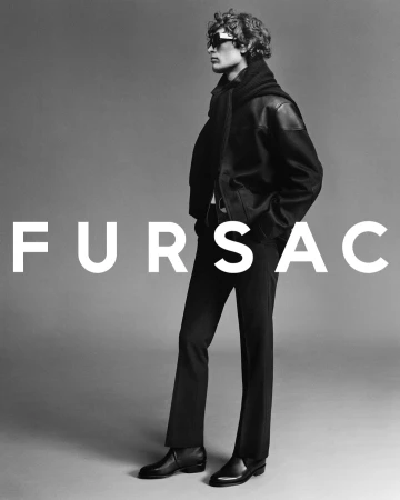 Model wearing dark jacket, scarf and sunglasses against a grey backdrop with bold white text overlaid
