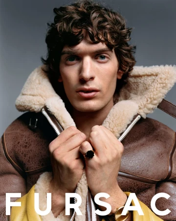 Close-up portrait of a male model wearing a brown shearling collar jacket against a grey background for Fursac.
