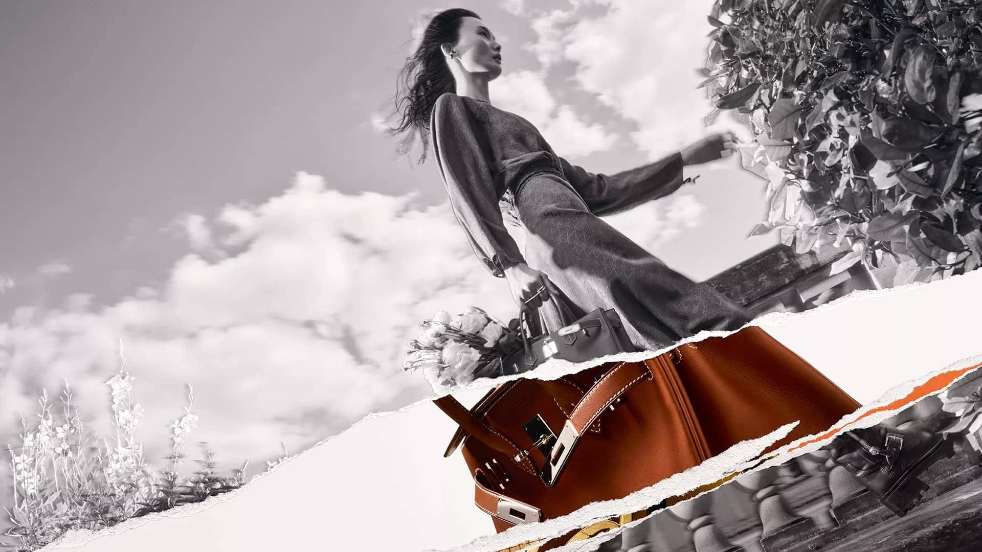 Monochrome fashion campaign image featuring a model holding a leather handbag outdoors against a cloudy sky with torn paper layers.