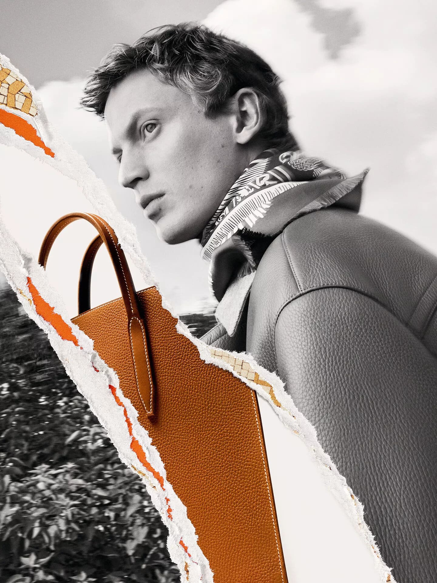 Man in leather jacket and patterned scarf beside a vibrant orange leather bag in a monochrome ripped paper collage