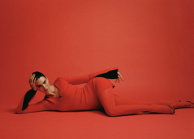 Kendall Jenner reclining in a red dress against a matching red studio backdrop for FWRD Fall 2024 ad campaign