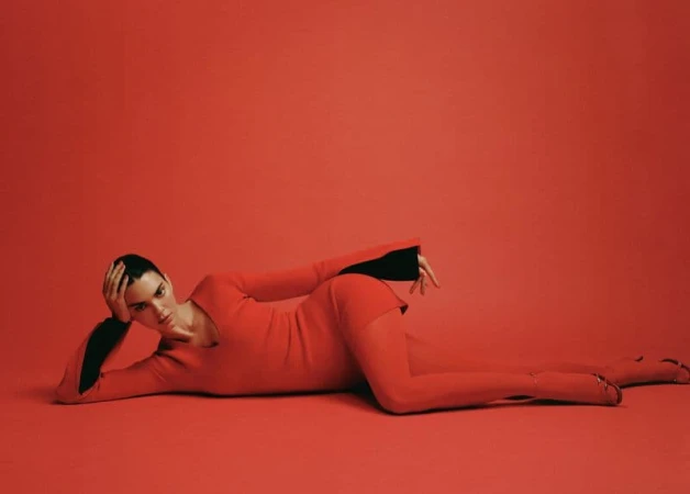 Kendall Jenner reclining in a red dress against a matching red studio backdrop for FWRD Fall 2024 ad campaign