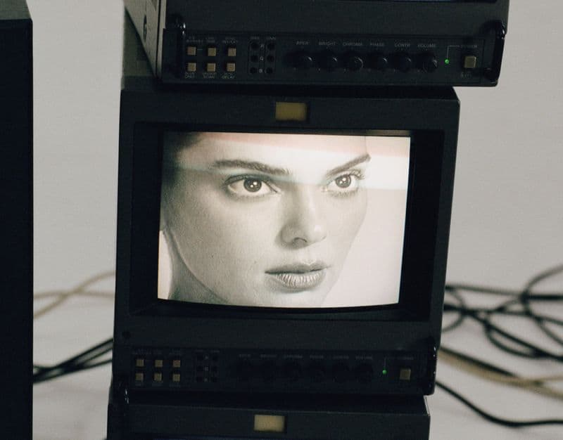 Close-up black and white monitor displaying Kendall Jenner's face for FWRD fall 2024 ad campaign