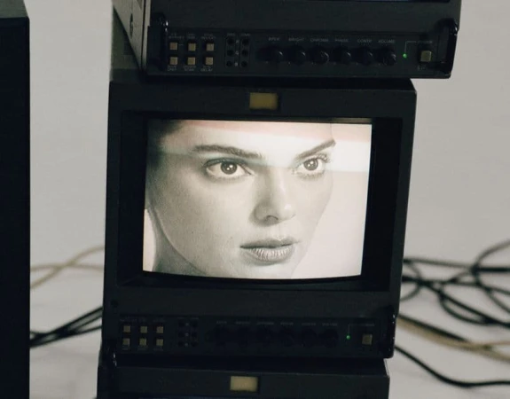 Close-up black and white monitor displaying Kendall Jenner's face for FWRD fall 2024 ad campaign