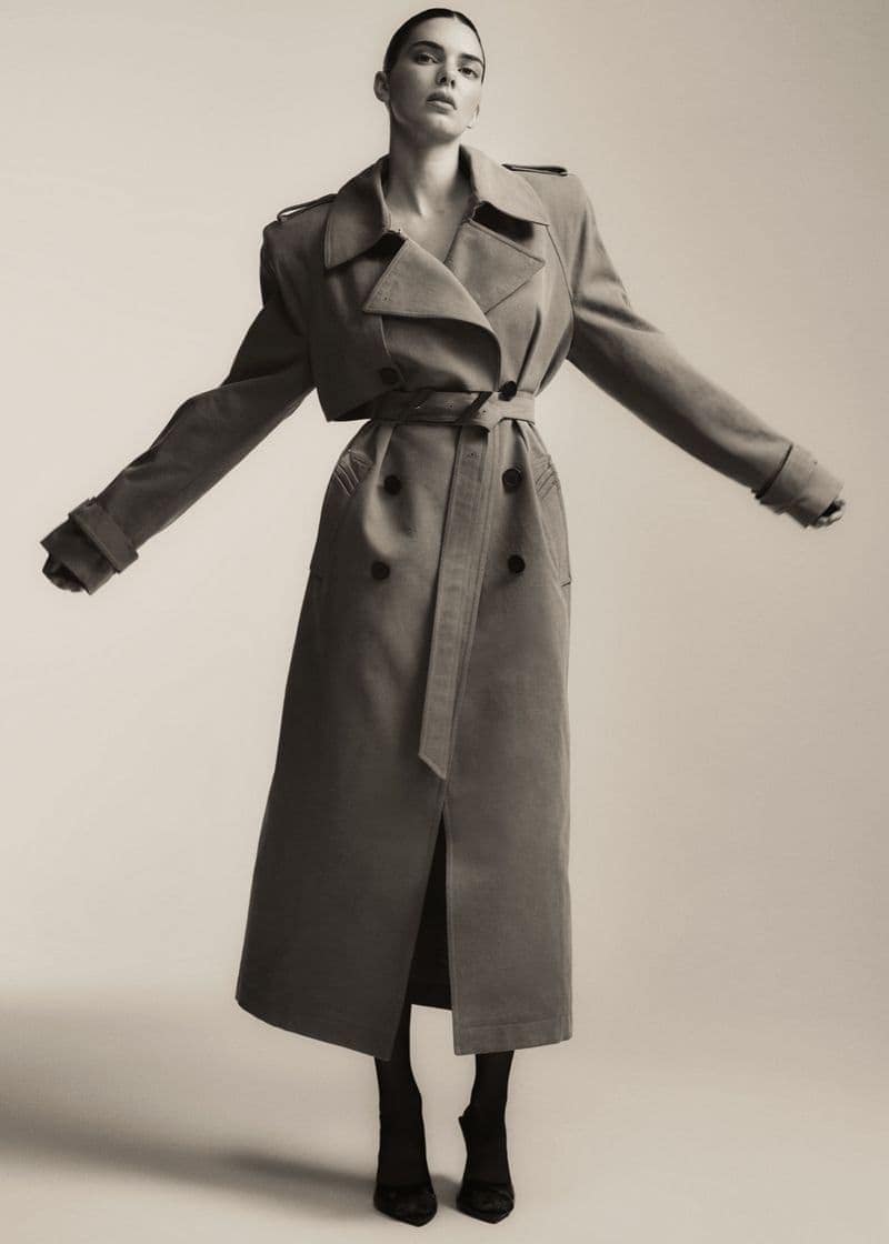 Kendall Jenner in a long belted trench coat against a plain studio background for the FWRD Fall 2024 campaign.