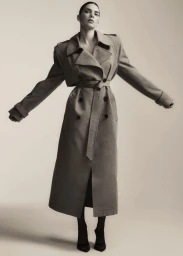 Kendall Jenner in a long belted trench coat against a plain studio background for the FWRD Fall 2024 campaign.