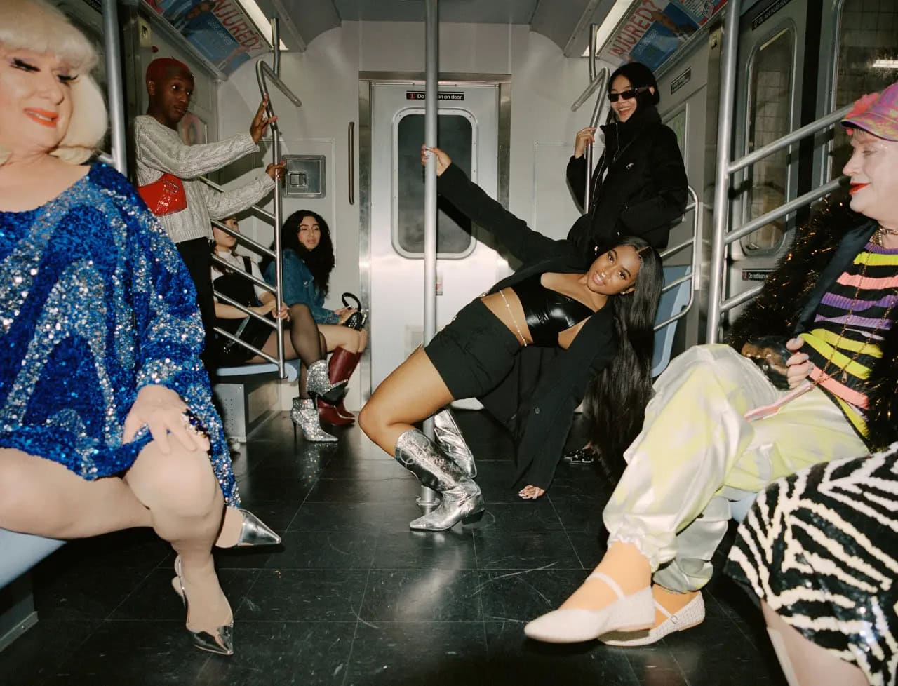 Group of diverse models posing inside a New York City subway car wearing Steve Madden footwear and apparel.