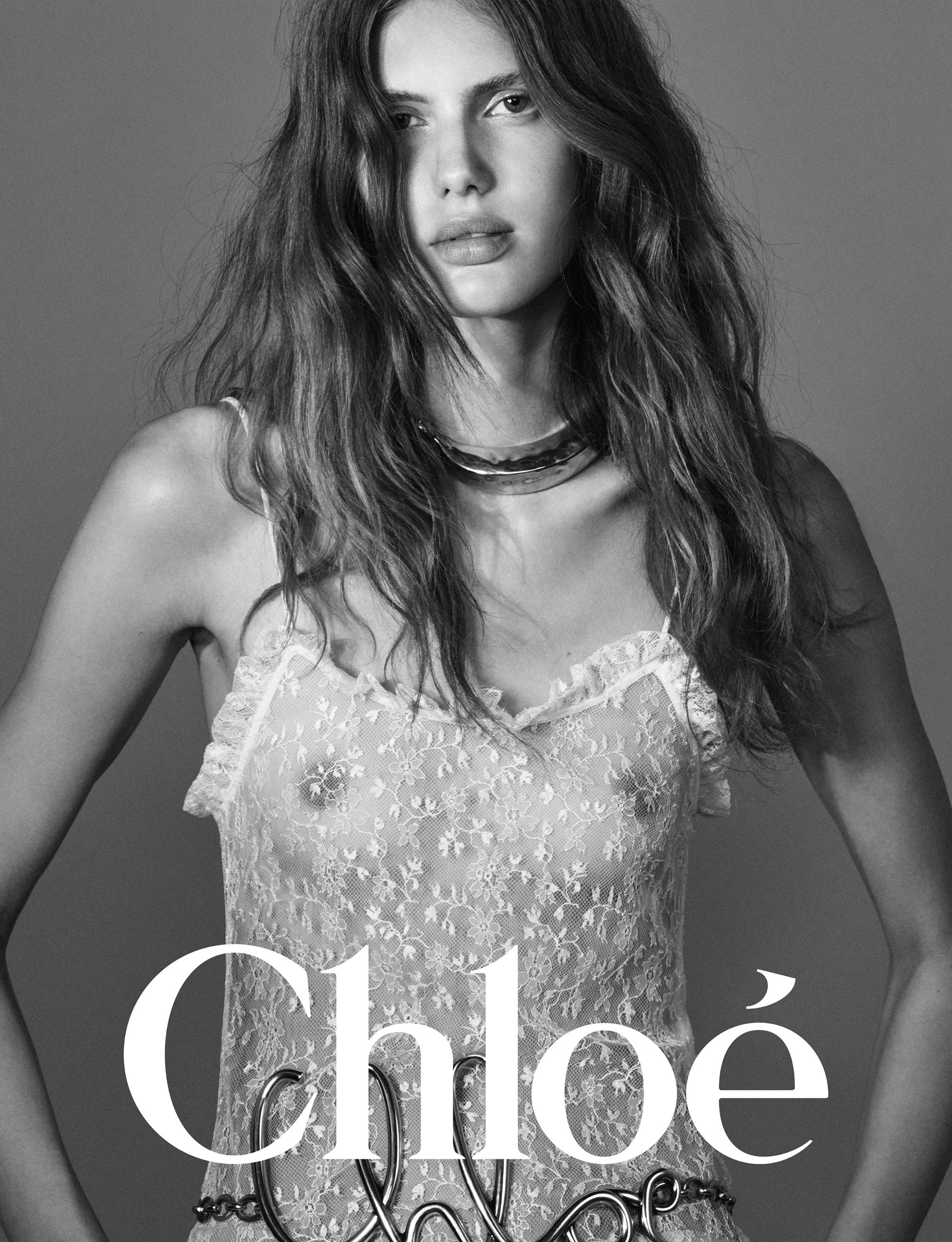 Model in lace slip dress wearing a metallic choker against a grey backdrop for Chloe