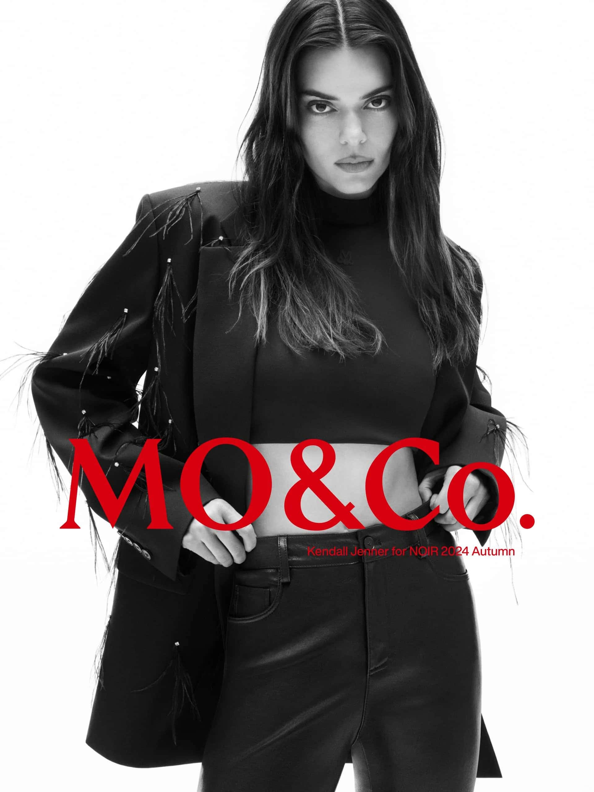Model Kendall Jenner wearing a black blazer and leather trousers against a white background for mo.co