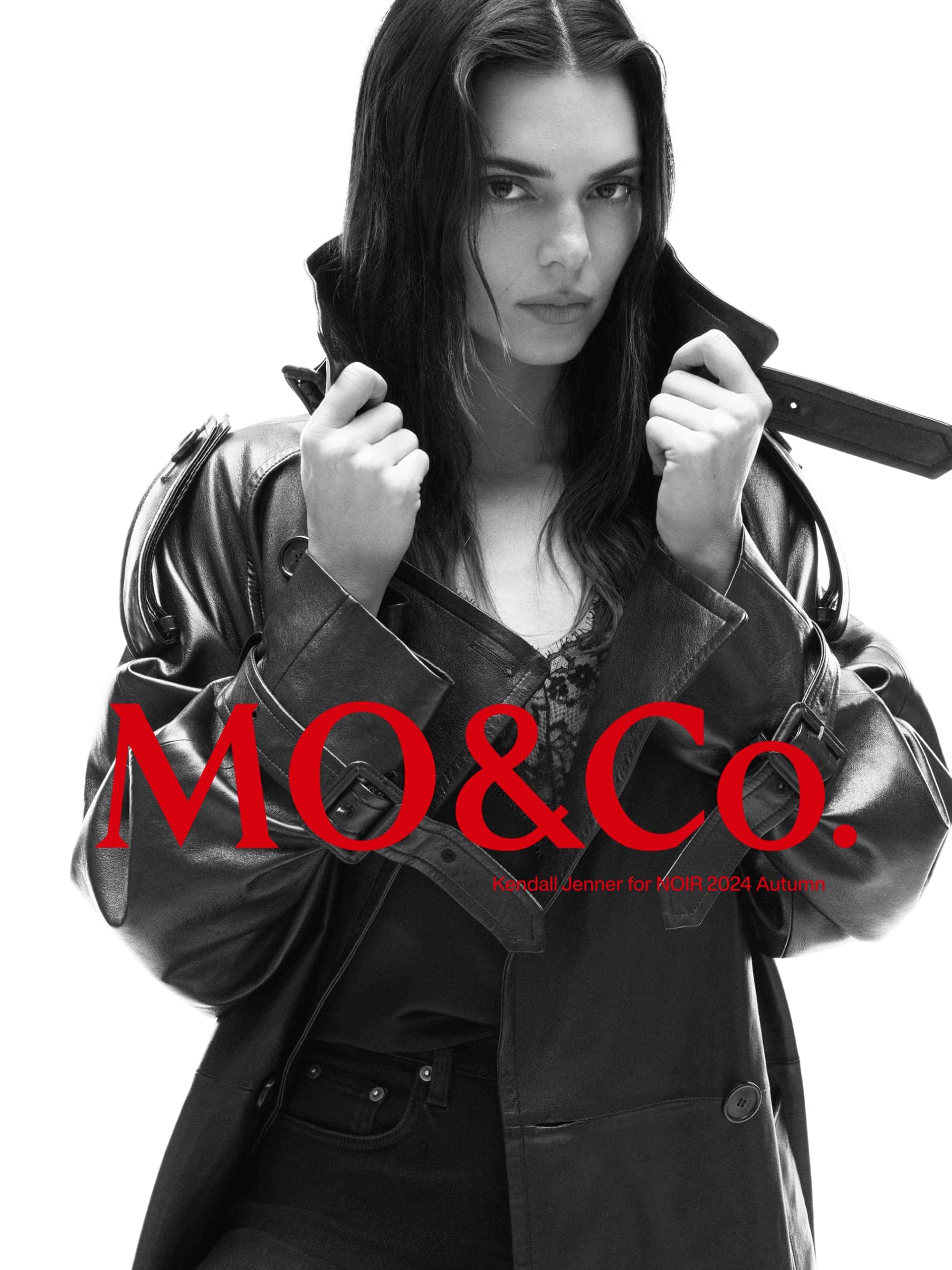 Kendall Jenner wearing a black leather coat against a white background for the mo.co NOIR 2024 campaign
