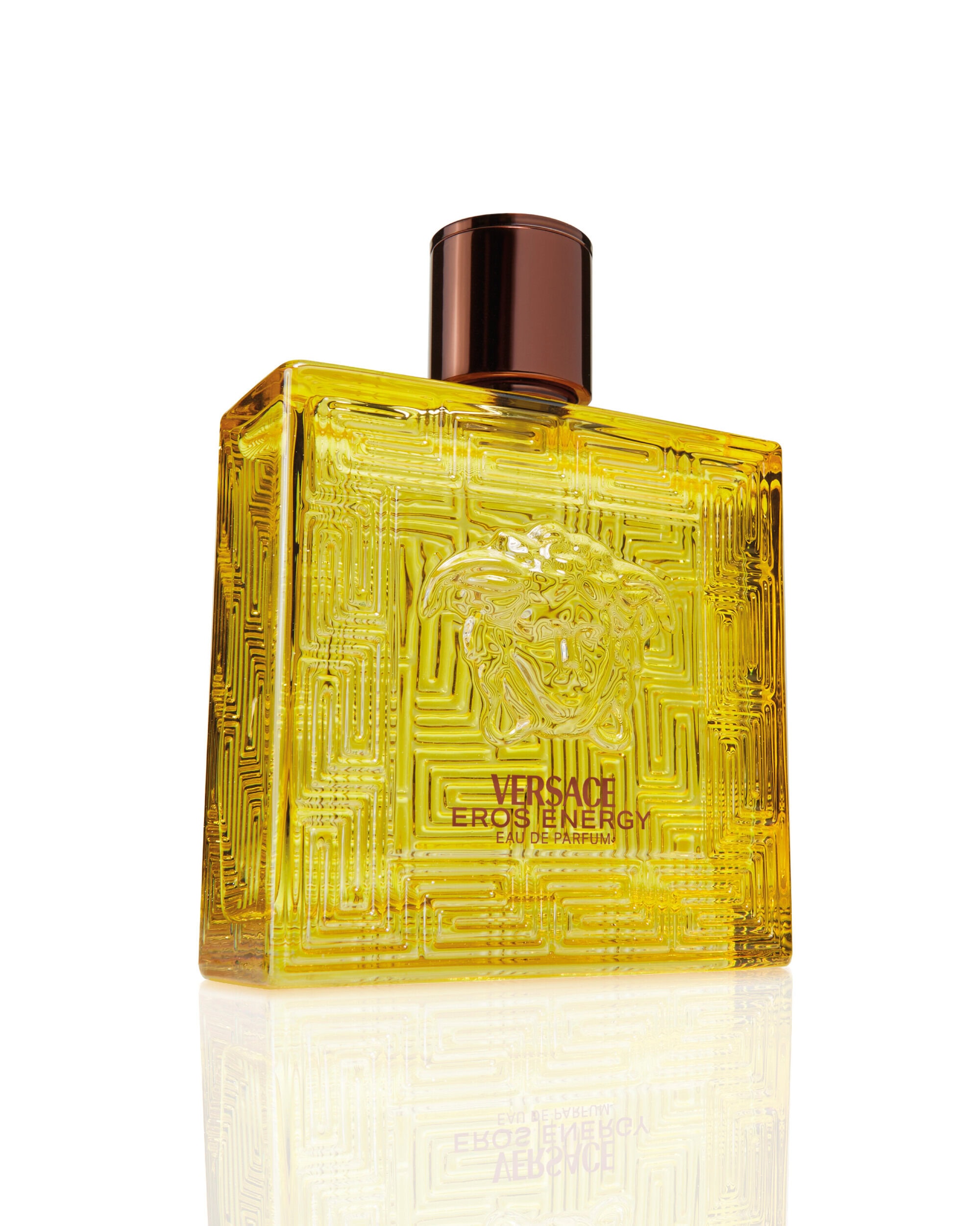 Versace Eros Energy perfume bottle with yellow liquid and dark cap against a bright white background