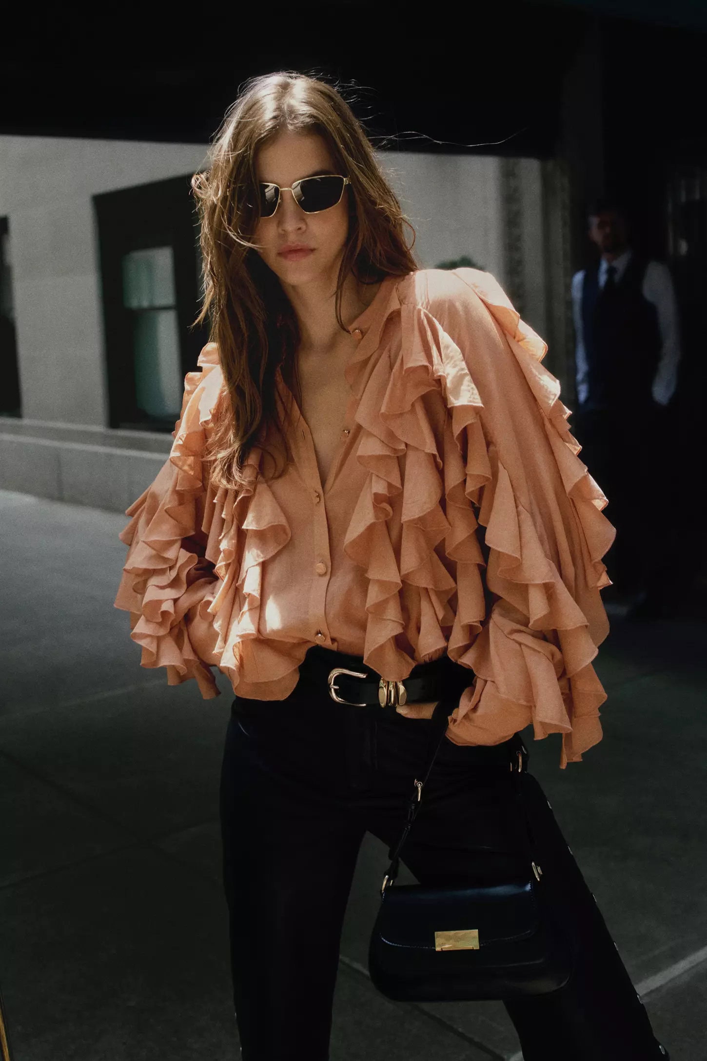 Barbara Palvin wearing a peach ruffled blouse and sunglasses outdoors for Anthropologie Fall 2024 ad campaign