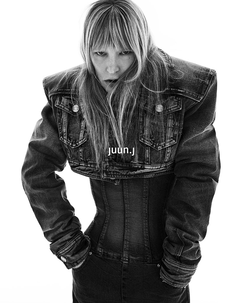 Model Kirsten Owen in an oversized denim jacket and corset for Juun.J Fall 2024 campaign, shot by Hong Janghyun against a white background.