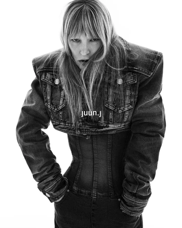 Model Kirsten Owen in an oversized denim jacket and corset for Juun.J Fall 2024 campaign, shot by Hong Janghyun against a white background.