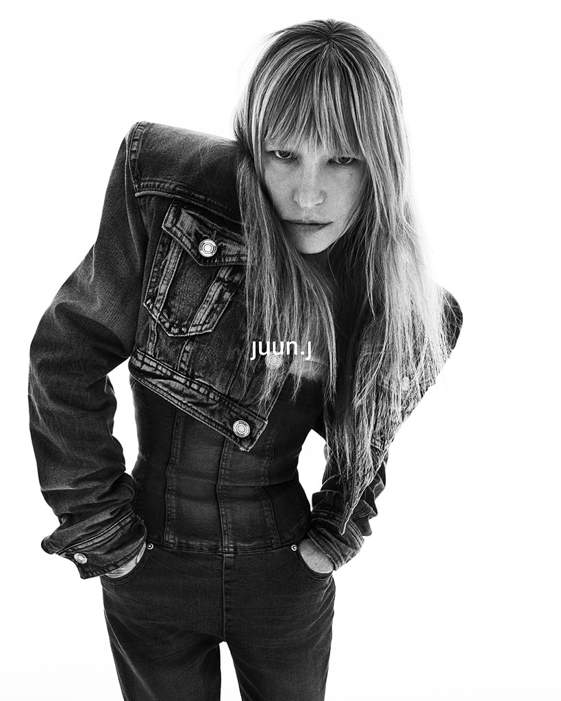 Model Kirsten Owen in a cropped denim jacket and dark pants against a white background for Juun.J Fall 2024 campaign.