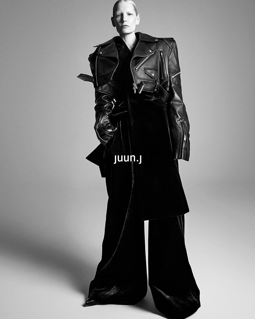 Model Kirsten Owen wearing an oversized black leather jacket and wide trousers in a monochrome Juun.J campaign ad