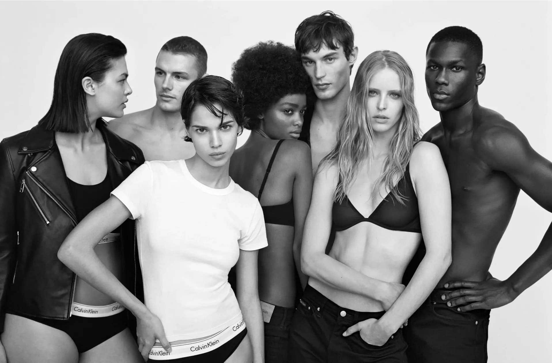 Black and white portrait of a diverse group of models posing for Calvin Klein shot by Alasdair McLellan.