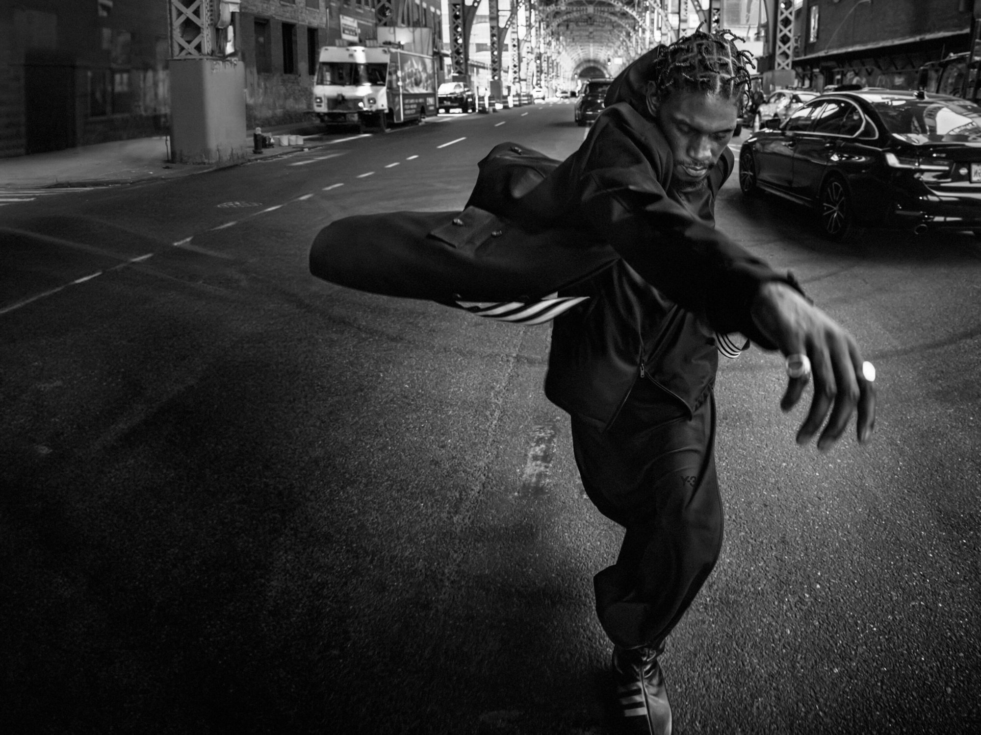 Man wearing dark sportswear in motion on a city street during the Y-3 Fall 2024 ad campaign photographed in New York City.
