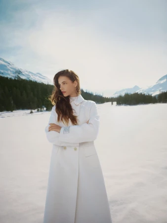 Barbara Palvin in a white coat standing in a snowy landscape for Ports 1961