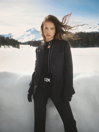 Barbara Palvin in a black blazer and trousers against a snowy mountain landscape for Ports 1961 fall campaign.