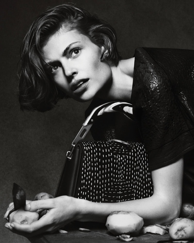 Model Bibi Breslin holding potatoes with a patterned black bag for Byredo photographed by Luis Alberto Rodriguez.