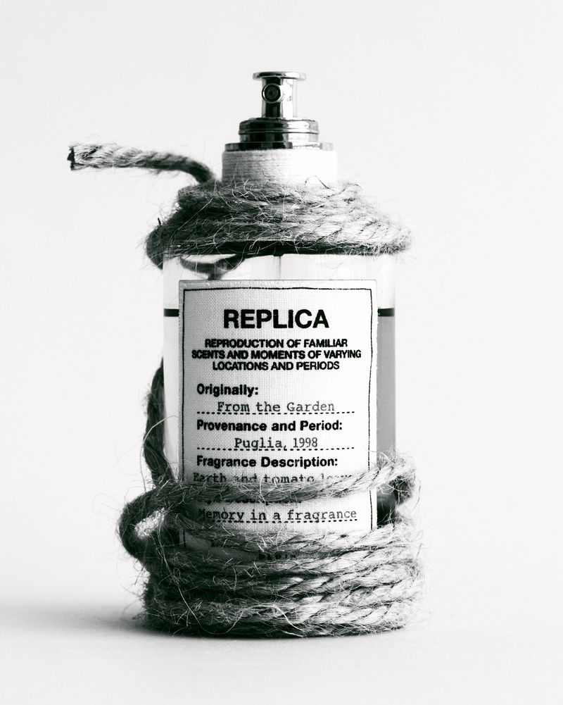 Perfume bottle wrapped with jute rope against a white background, featuring a vintage-inspired label with black typography and a metal pump.