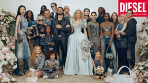 A diverse group of models posing in denim outfits and wedding attire flanking a bride in a light blue ballgown with floral arrangements.