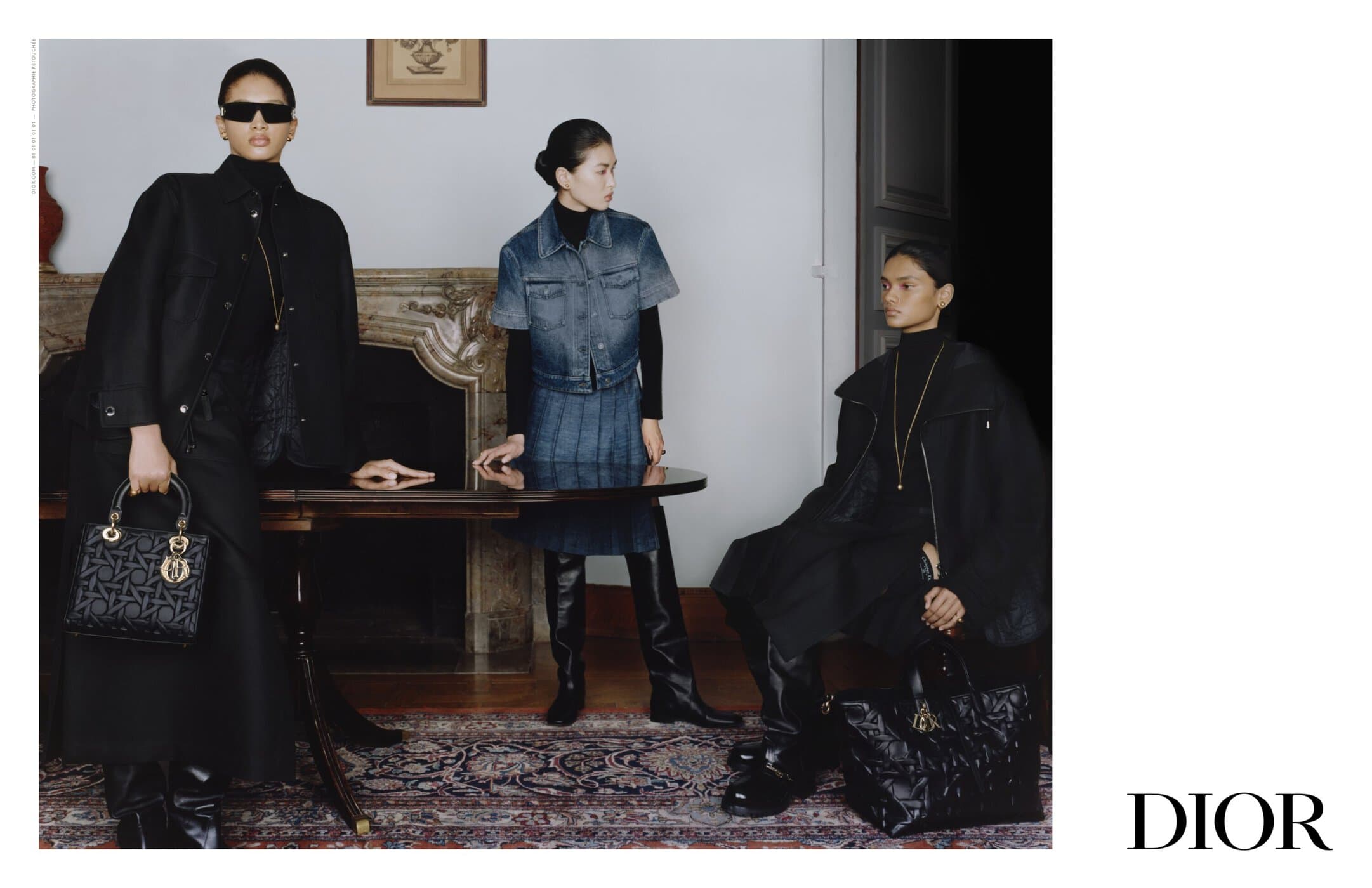 Three women model black and denim outfits and purses indoors, posing near a wooden table and fireplace, with a 'DIOR' logo visible.