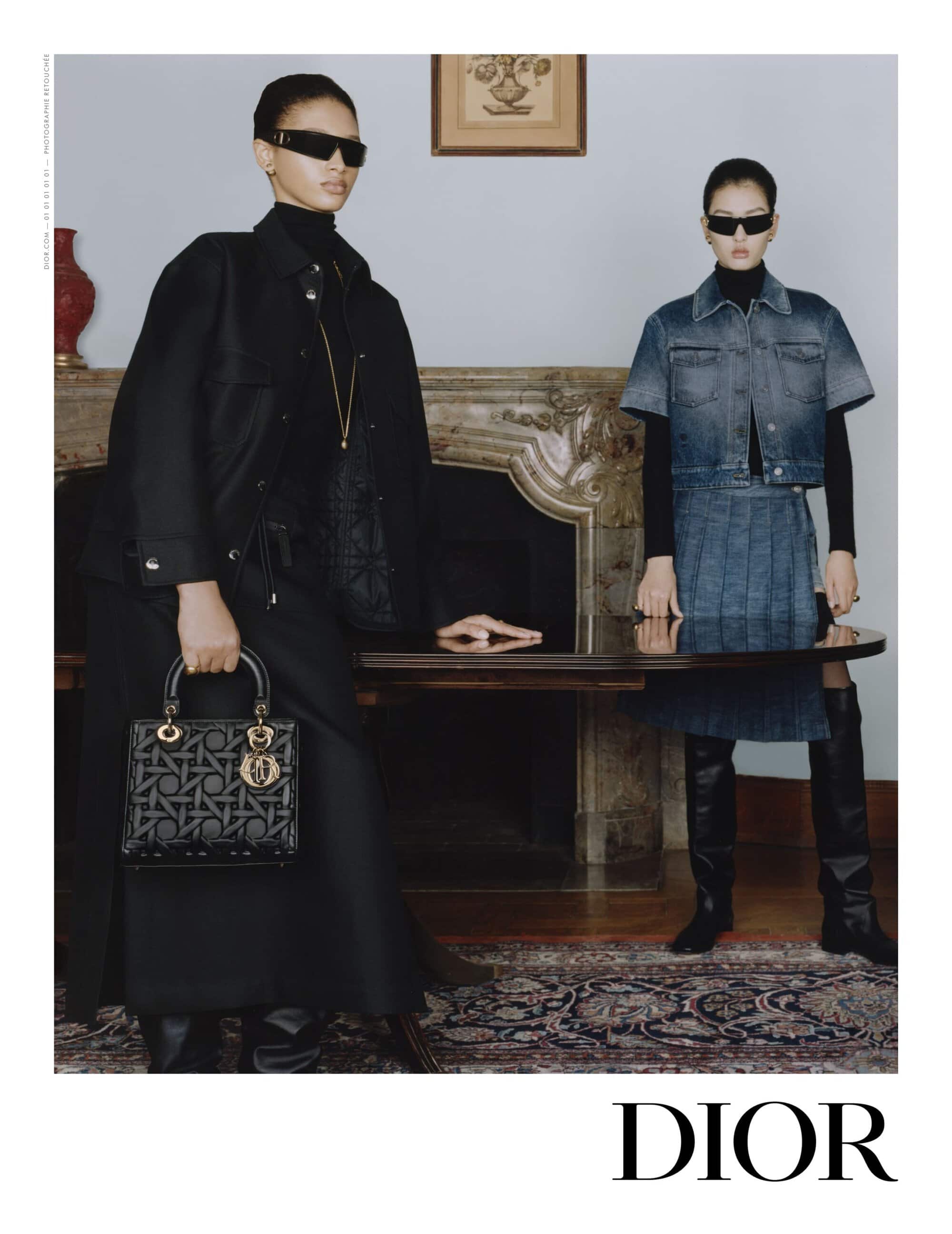 Two models wearing dark sunglasses and black turtlenecks standing near a fireplace for Dior Fall 2024 campaign