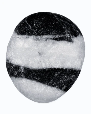 Striking black and white stone displaying distinct layers. Its smooth surface and clear contrasts make it a minimalist visual element.