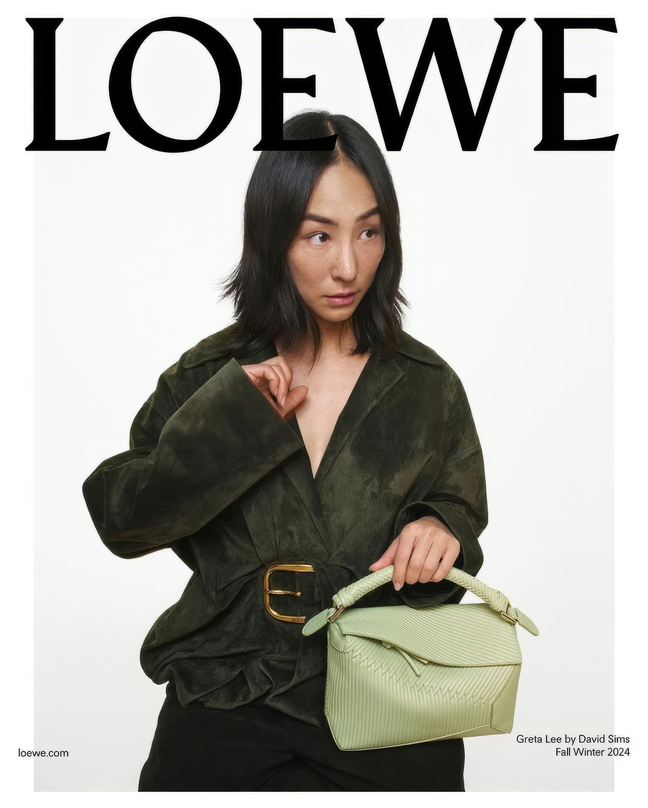 Fashion editorial featuring an Asian female model in a green jacket and black pants, holding a light green handbag against a white backdrop.