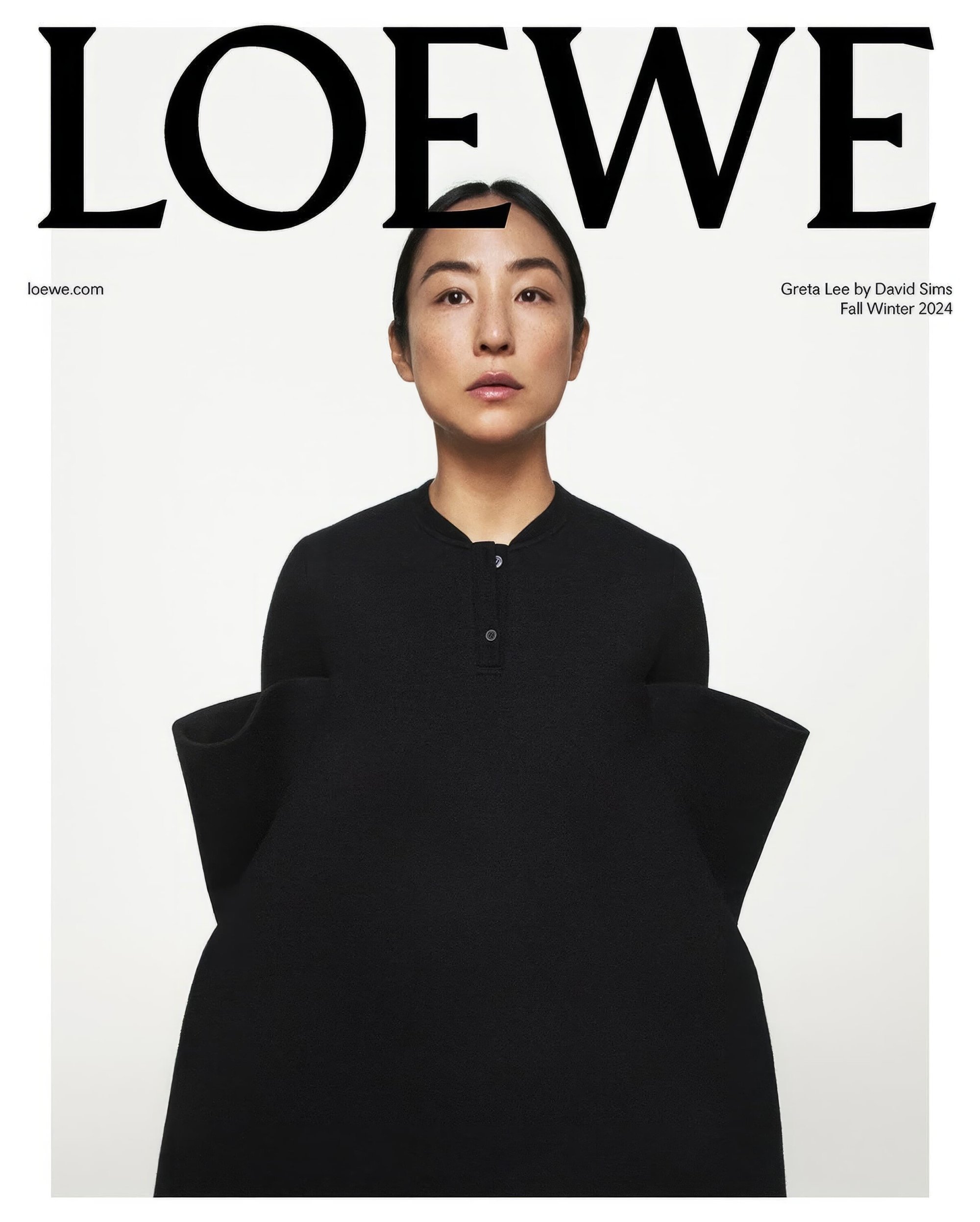 Fashion editorial shot featuring an Asian woman with sleek hair wearing a black dress and standing against a clean white background.