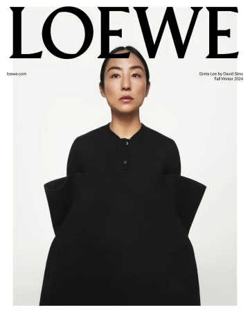 Fashion editorial shot featuring an Asian woman with sleek hair wearing a black dress and standing against a clean white background.