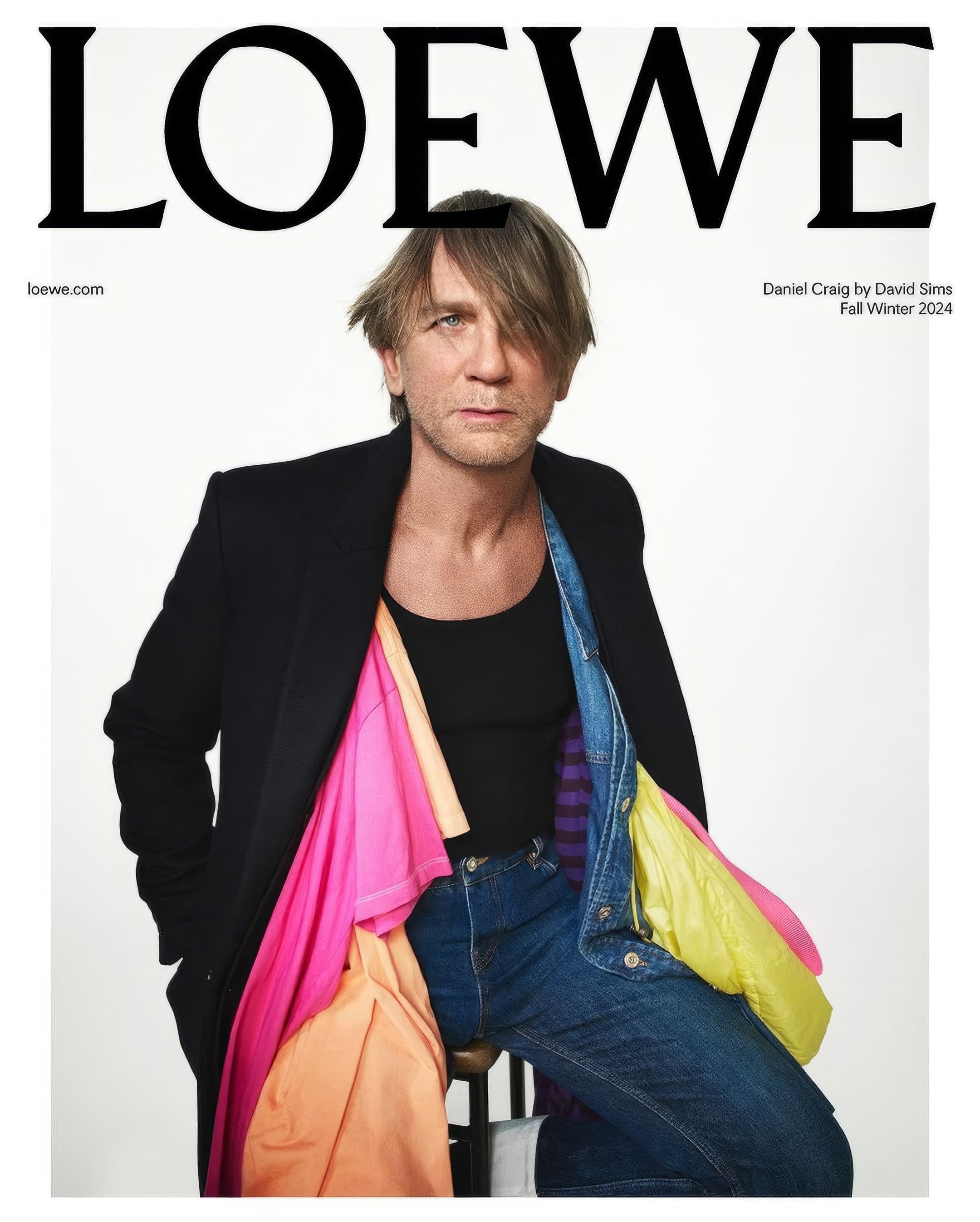 Fashion magazine cover featuring Daniel Craig in a black blazer, jeans, and colorful shirts, with the LOEWE logo at the top.