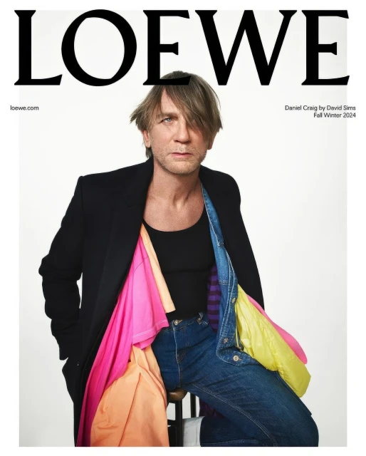 Fashion magazine cover featuring Daniel Craig in a black blazer, jeans, and colorful shirts, with the LOEWE logo at the top.