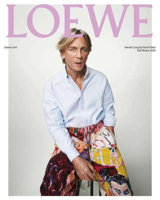 Magazine cover featuring Daniel Craig wearing a blue button-down shirt and colorful patterned pants, with the brand name 'LOEWE' above him.