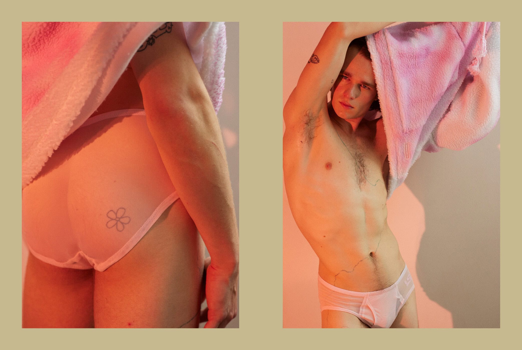 A shirtless adult male stands indoors wearing underwear and a robe in a studio setting with pink and orange lighting and fair skin.