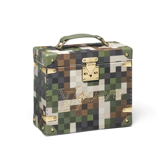 Louis Vuitton box trunk featuring a pixelated camouflage pattern with gold hardware, and a handle on a white background.