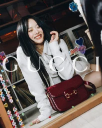 Model Hanni smiling next to a burgundy Gucci Horsebit handbag for the Summer 2024 ad campaign