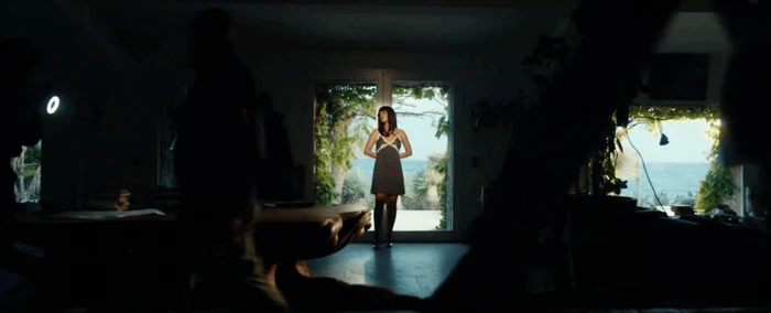 Model Adele Exarchopoulos standing in a doorway overlooking the sea in Marcia campaign