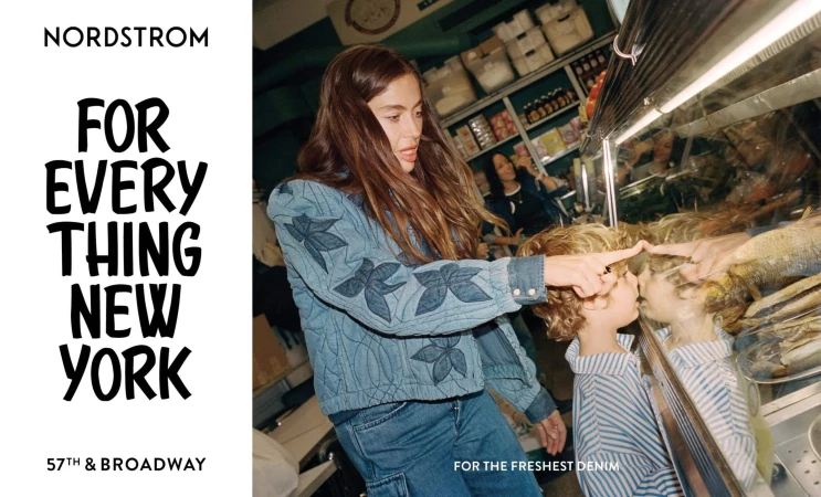 A woman in a denim jacket points to a child with curly hair looking at a display case, with a Nordstrom ad visible.