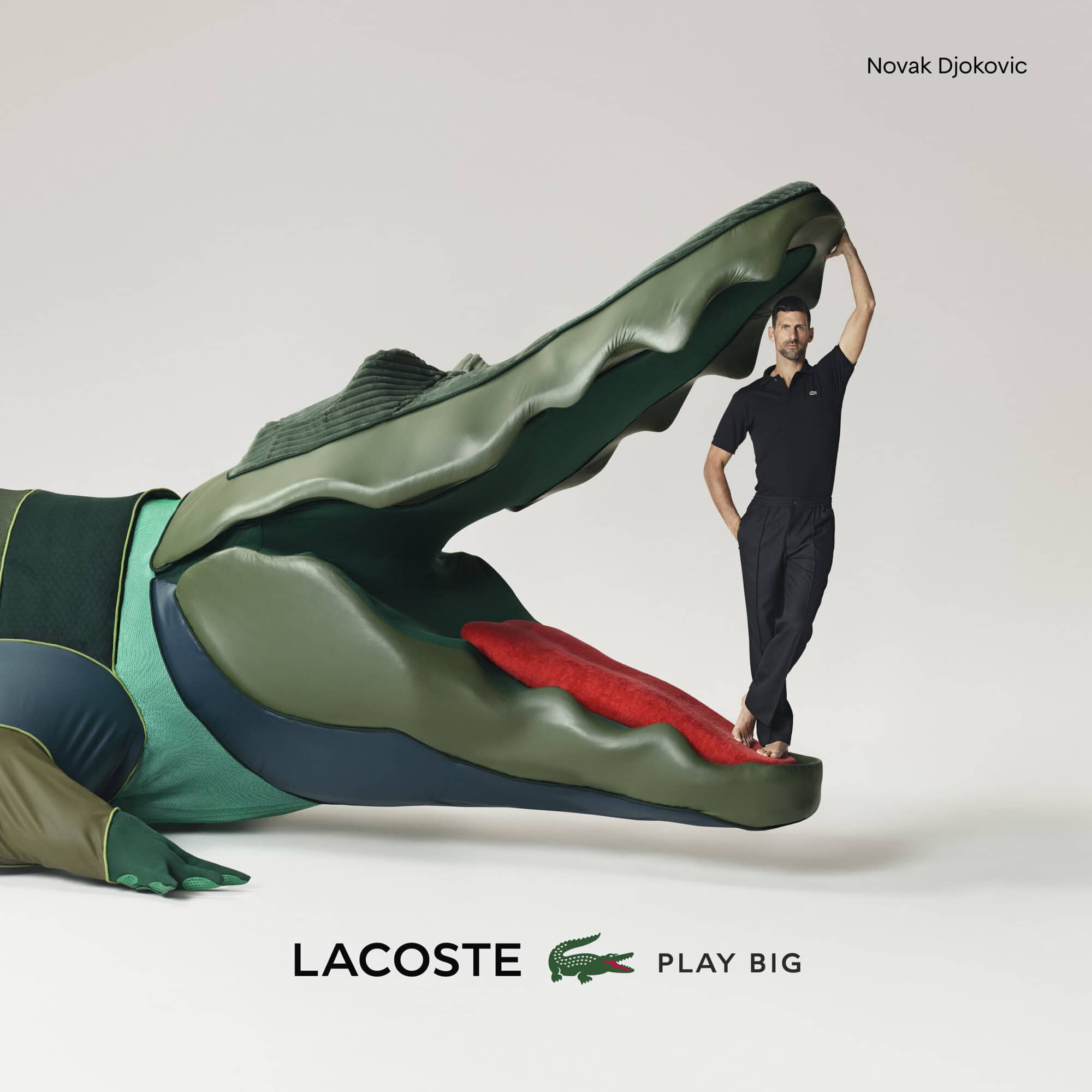 Novak Djokovic is positioned near a large Lacoste alligator figure in a studio shot, promoting the brand with 'Play Big' slogan.