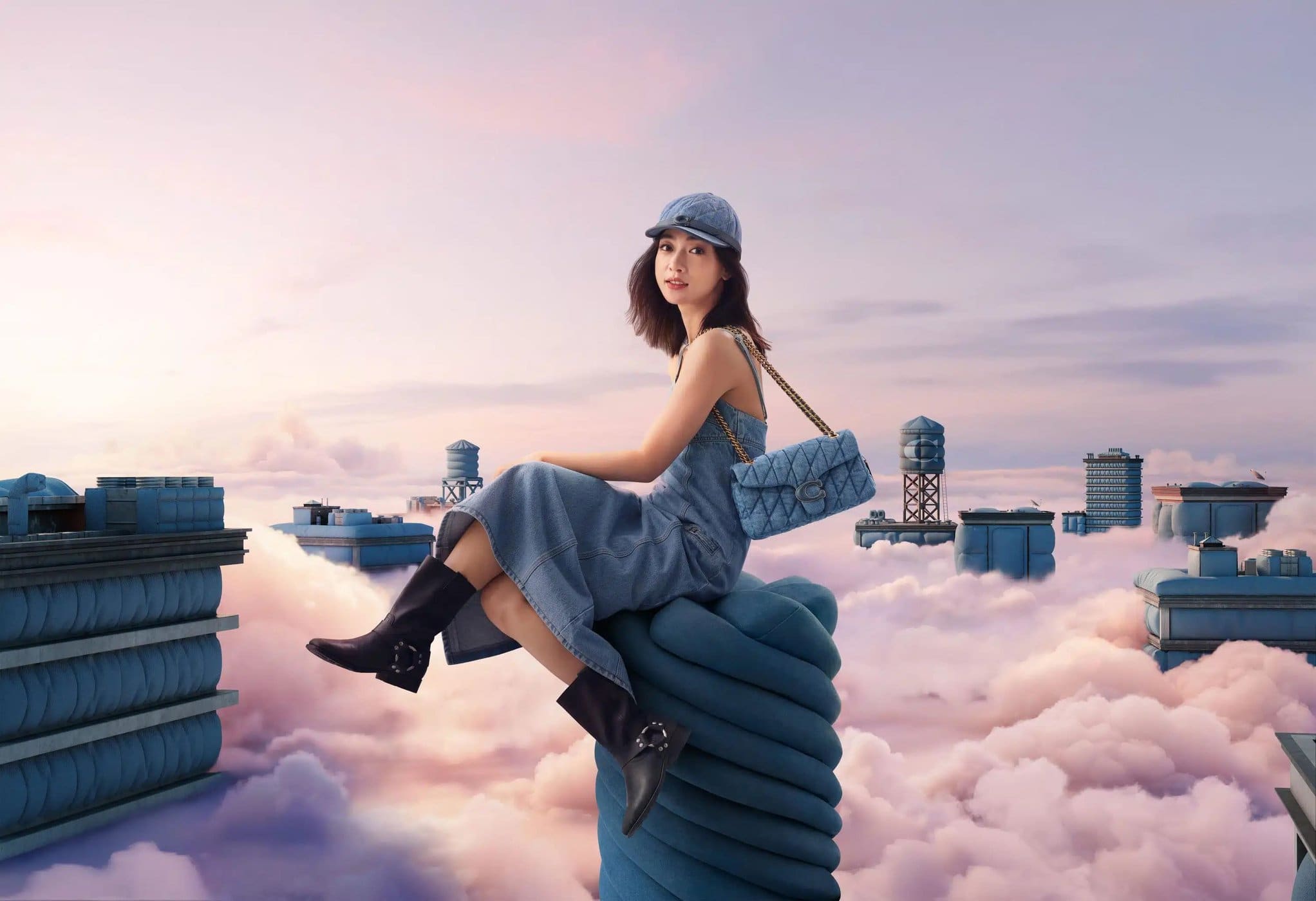 A fashionable woman wearing a denim dress and hat sits on a blue sculpture with a purse, set against a whimsical cityscape background.