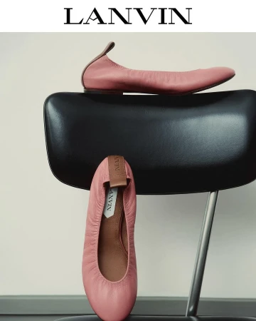 Elegant Lanvin ballet flats in pink leather, positioned on a modern black chair against a neutral backdrop. High-fashion footwear.