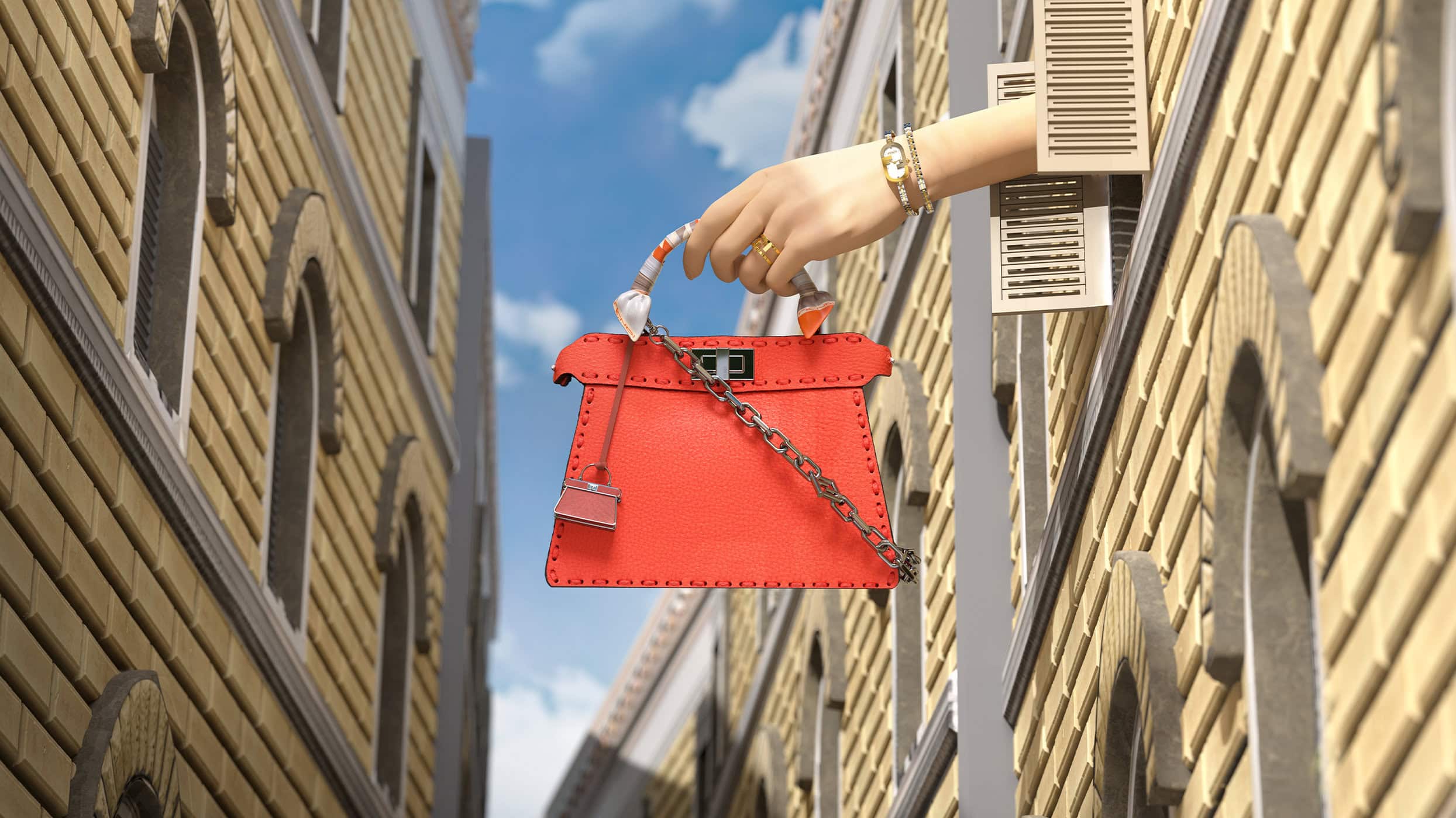 Fashion handbag in coral color, held by a hand with jewelry in an outdoor urban setting with tall buildings and blue sky.